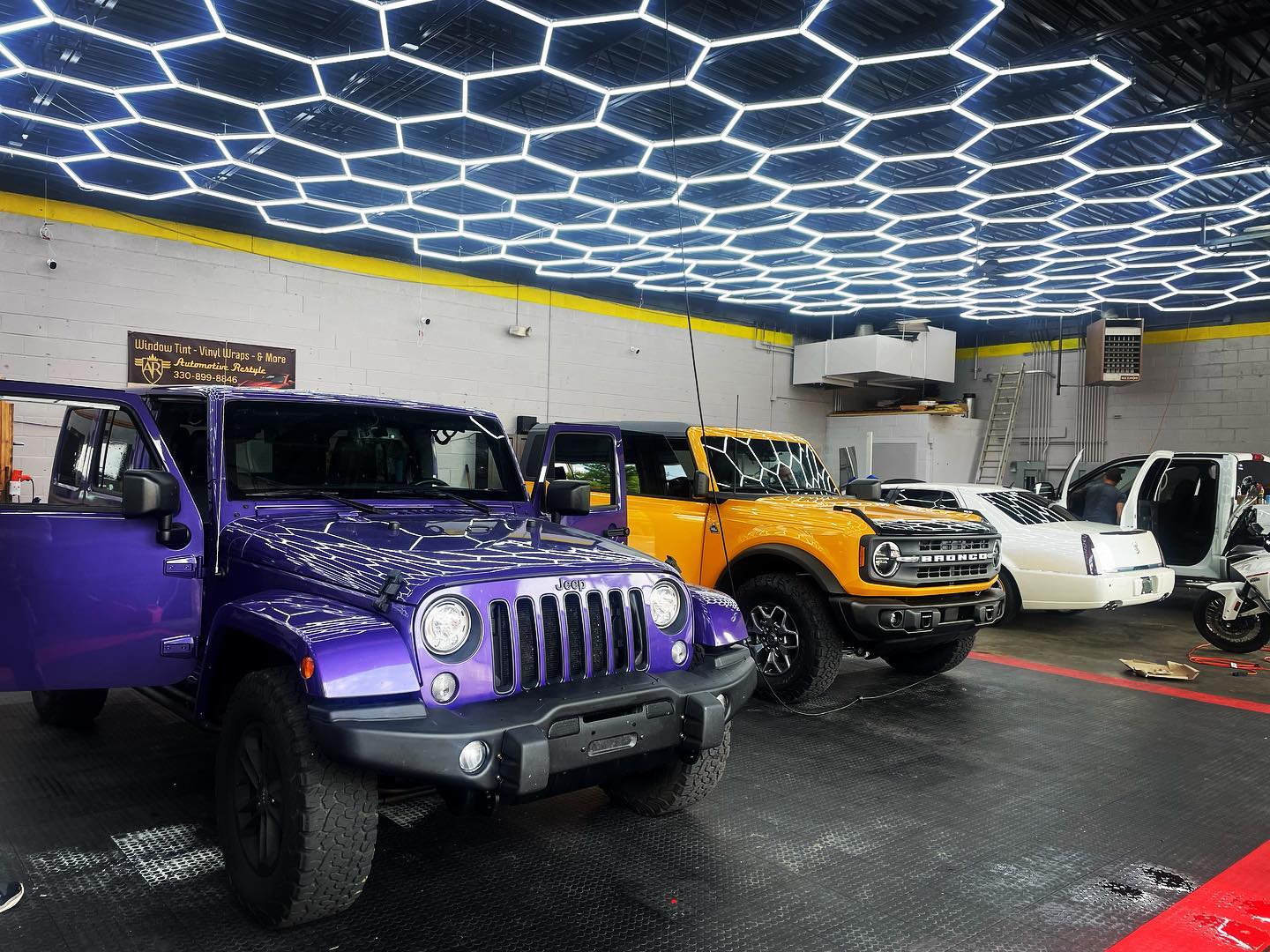 Cars under led hexagon lights in garage